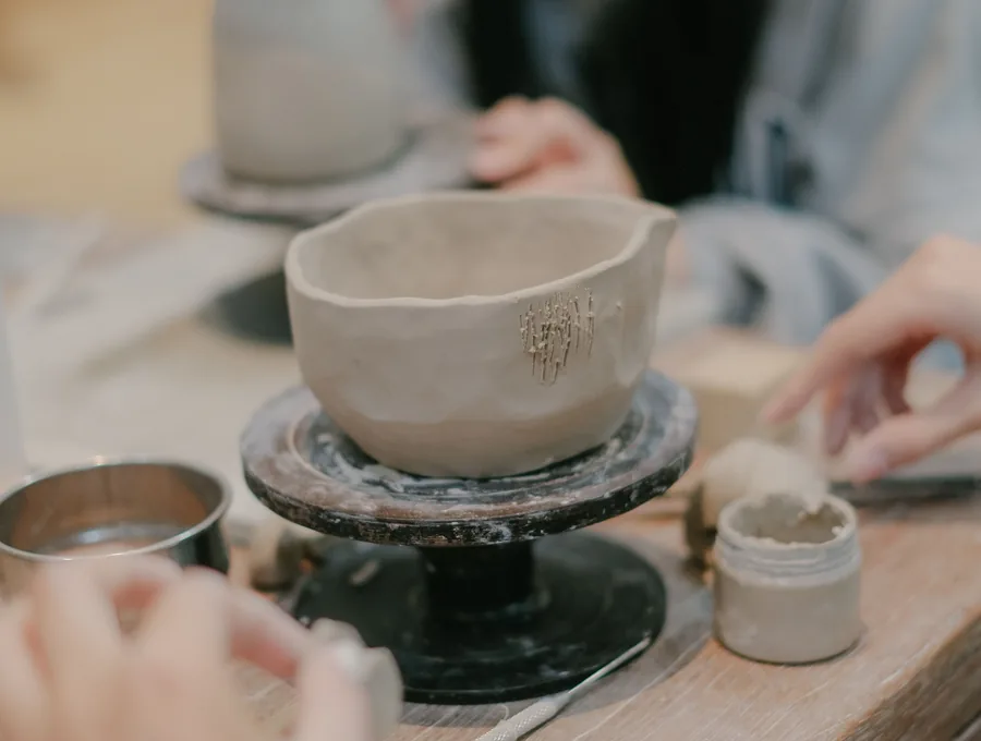 A person hosting a pottery experience